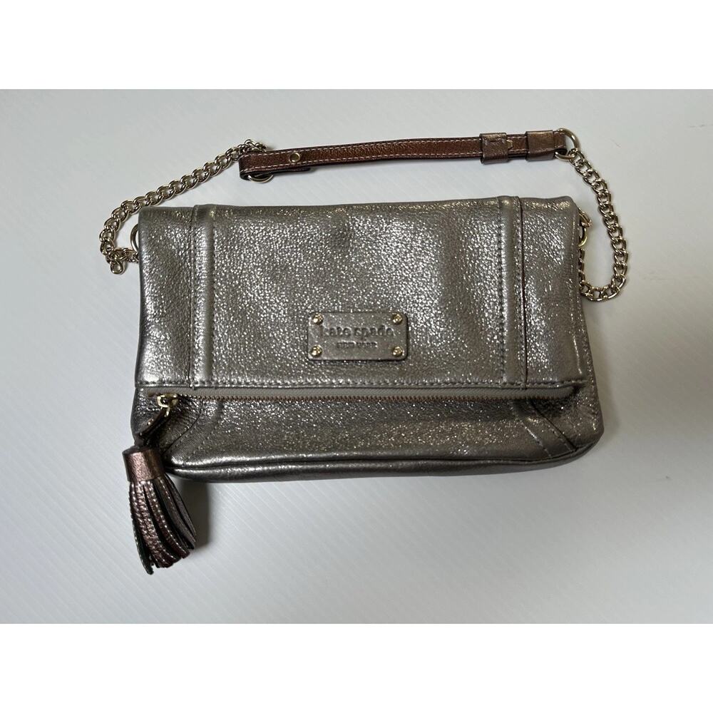 Kate Spade metallic leather crossbody bag with a tassel and chain strap